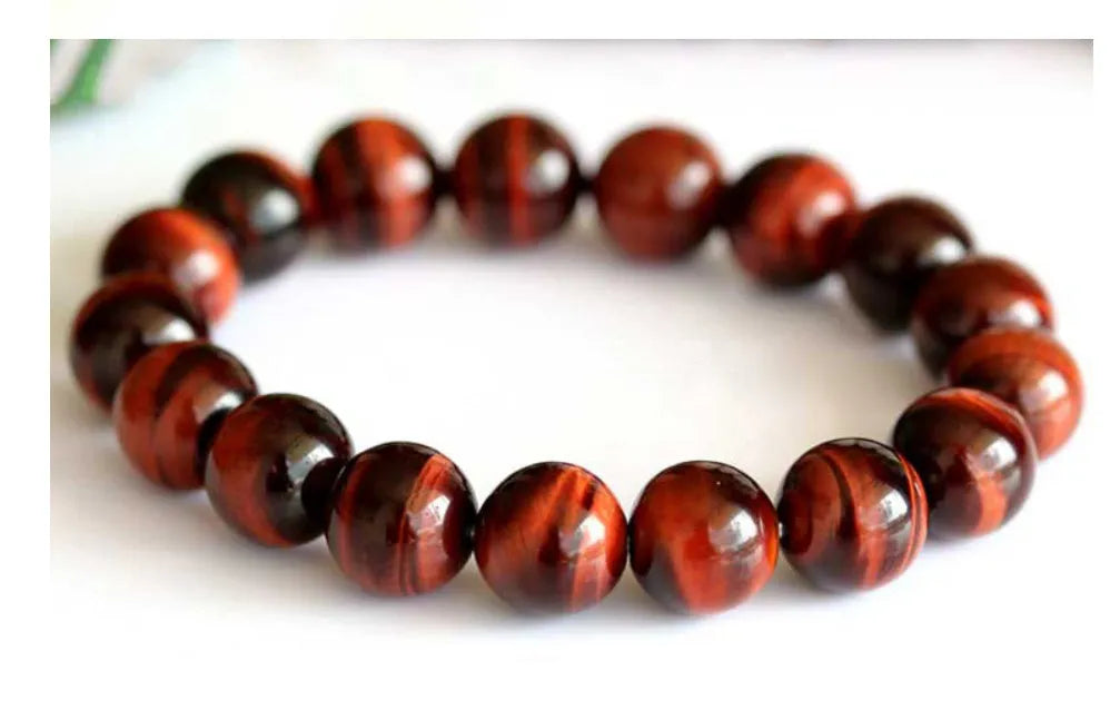 Geometric wood alexandrite bracelet with round beads showing Lightning Cat's Eye effect.