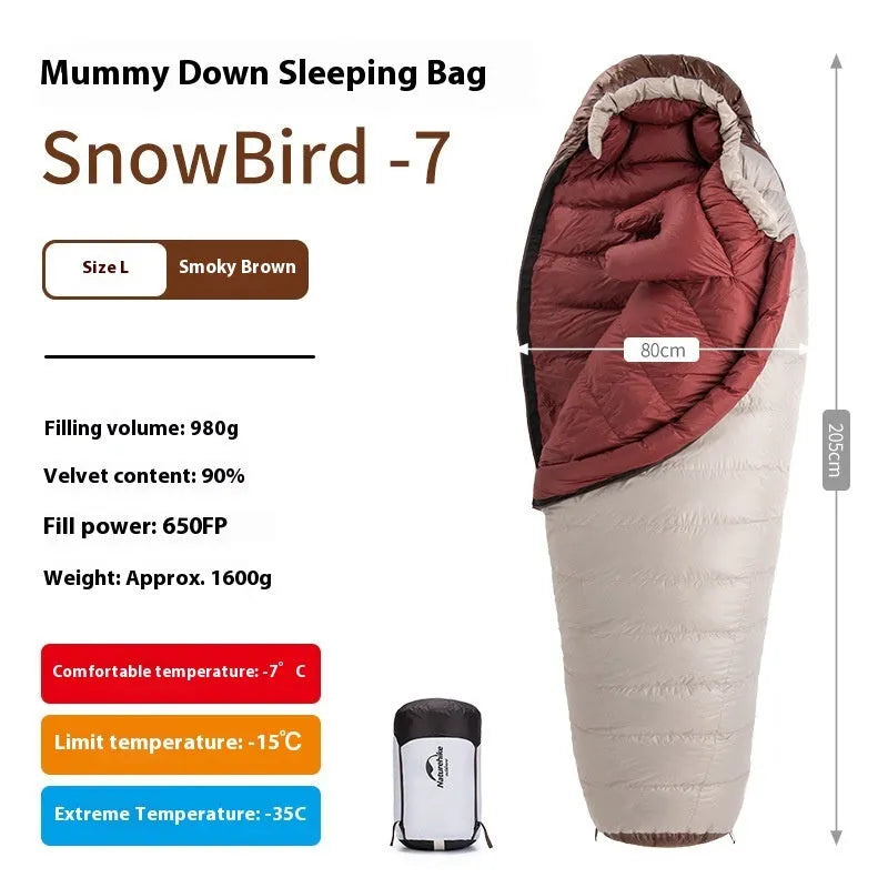 Goose down mummy sleeping bag in a stuff sack, part of the snowbird range for camping.