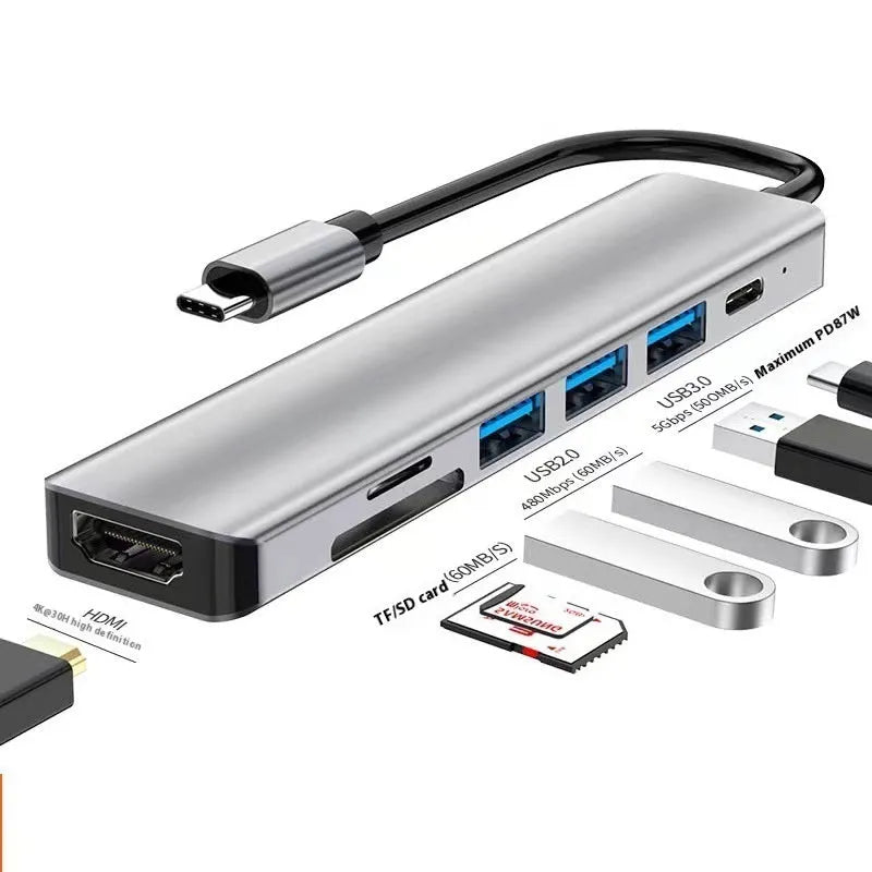 Silver aluminium USB-C 7-in-1 expansion dock with HDMI, USB ports, SD slots, and a 15cm cable.