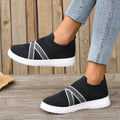 Women's black flyknit mesh outdoor shoes with flat rubber sole and tassel detail.