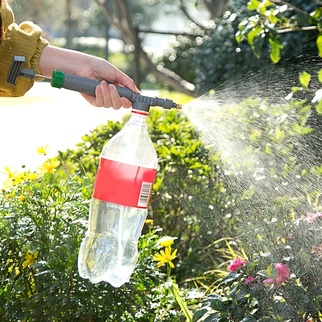 Grey watering sprayer nozzle attached to plastic bottle with 30cm connecting tube for garden watering