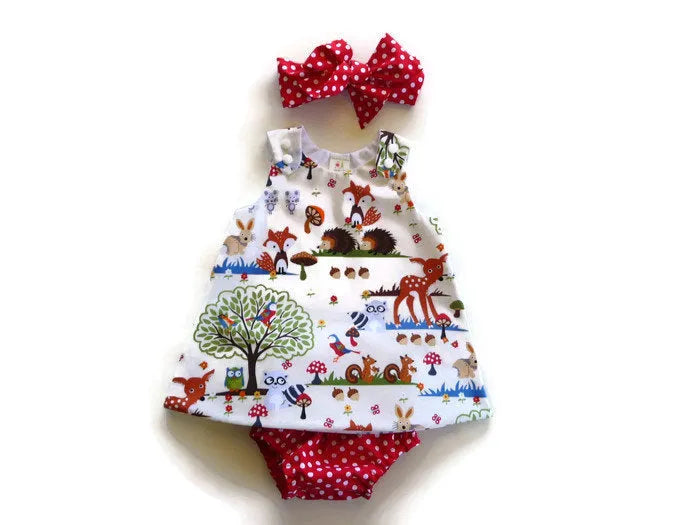 Red cartoon design three-piece children's summer suit with dress, shorts, and headband