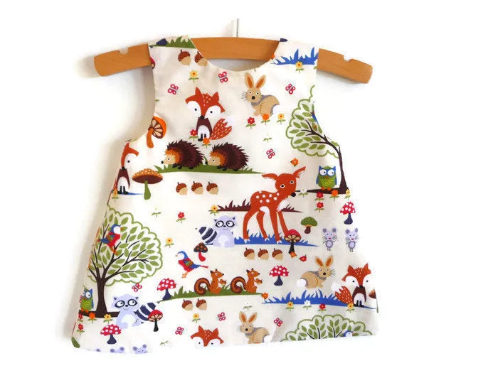 Red cartoon design three-piece children's summer suit with dress, shorts, and headband
