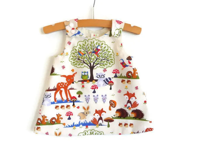 Red cartoon design three-piece children's summer suit with dress, shorts, and headband