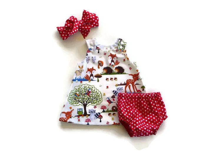 Red cartoon design three-piece children's summer suit with dress, shorts, and headband