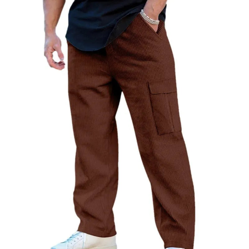 Men's loose-fitting corduroy cargo trousers in a brick red colour with a wide-leg silhouette.