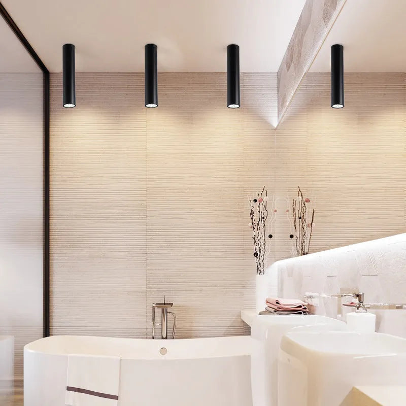 Black round surface mounted LED ceiling downlight spotlight in warm white or cool white light.