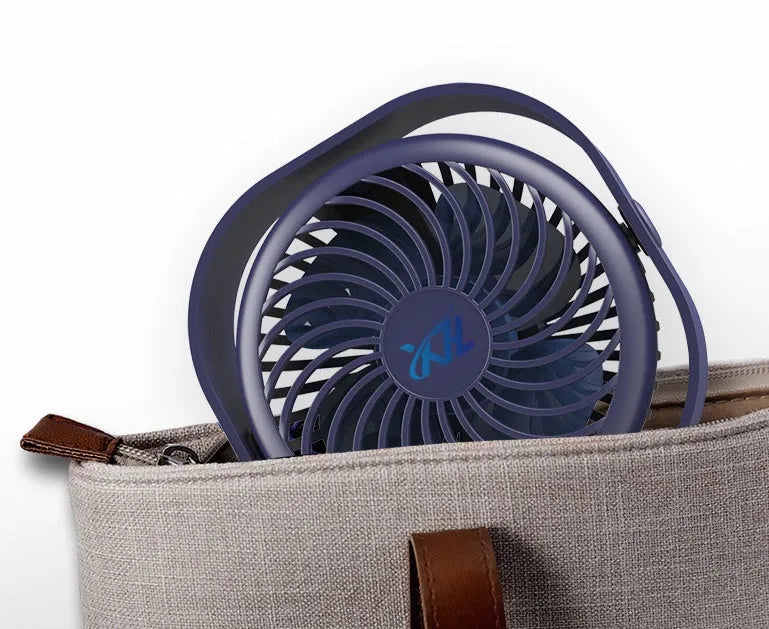 USB desk fan with 360-degree rotation in blue, on a desk next to a laptop.