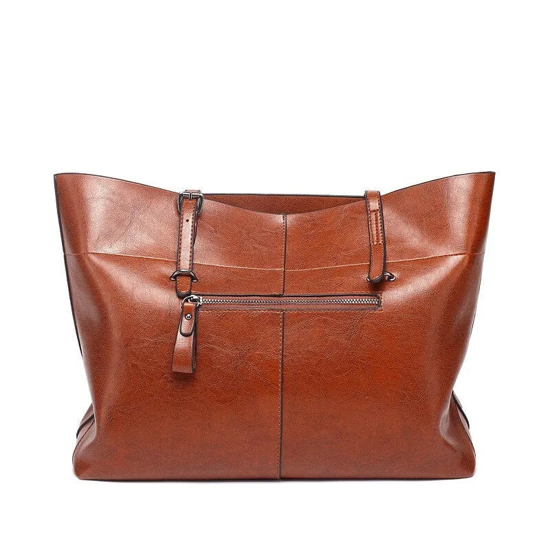 Brown waxed cowhide crossbody handbag showing two main compartments and an internal phone pocket.