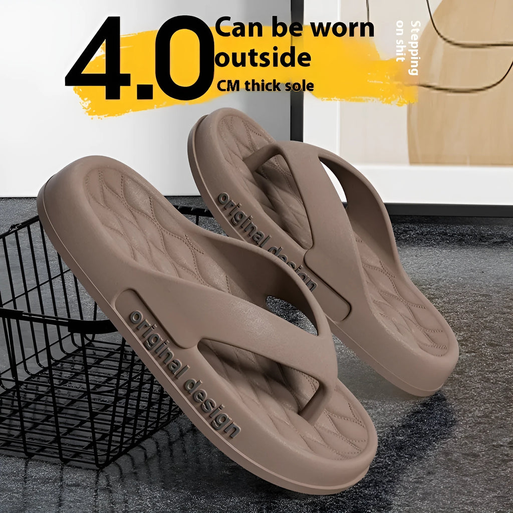 Men's EVA flip flops in black on a sandy beach, showing open toe design.