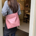 Pink corduroy one-shoulder commuter bag with dimensions 39cm by 32cm.
