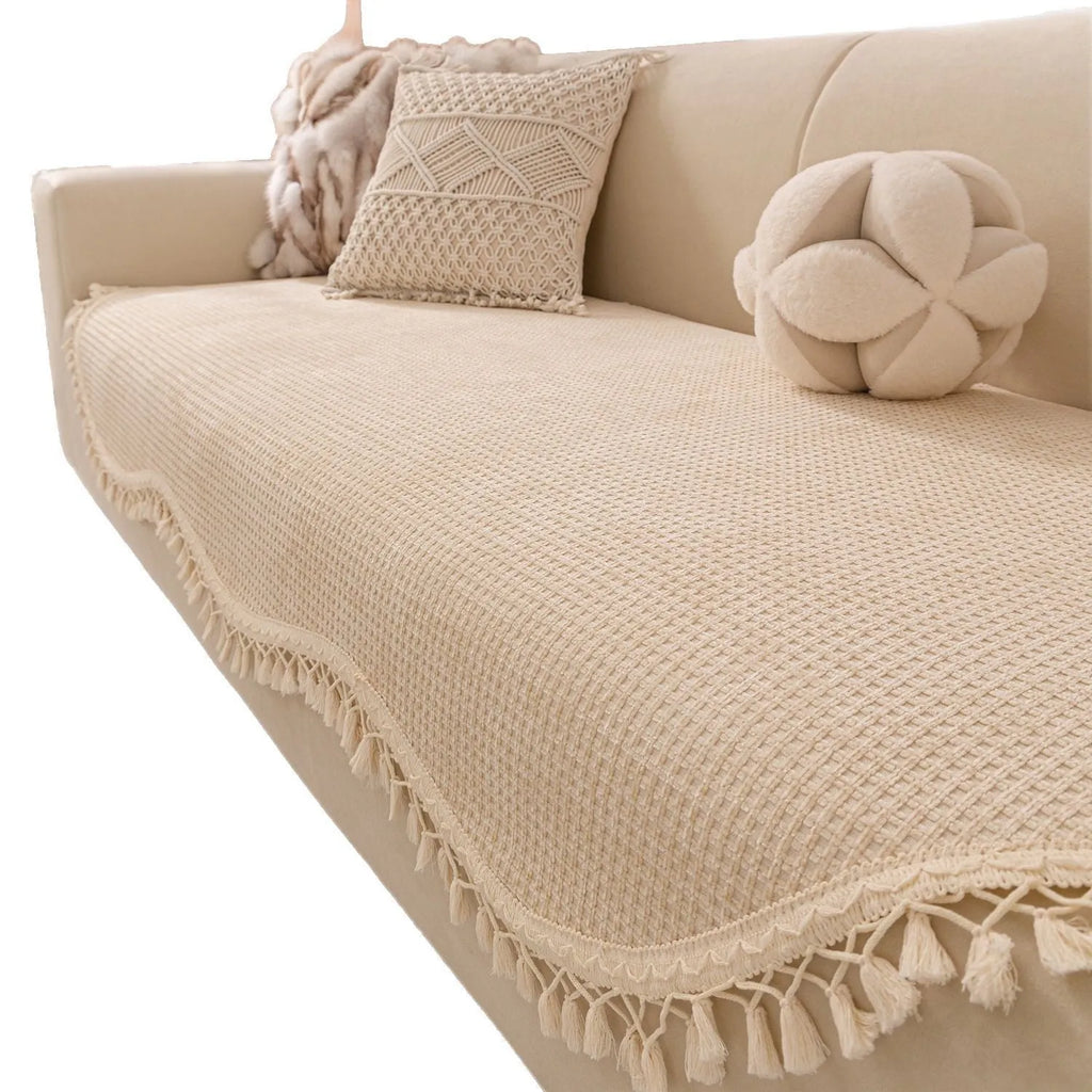 Ivory white non-slip short plush polyester sofa cover with tassle fringe on a sofa seat