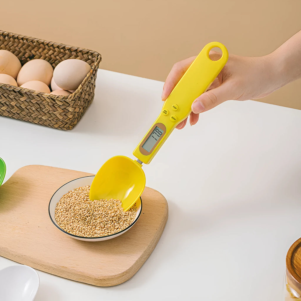 White digital spoon kitchen scale with LCD display showing weight measurement