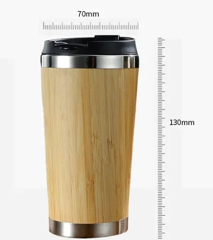 Bamboo coffee cup with double wall insulation, leak-proof lid, and non-slip foam pad on a table