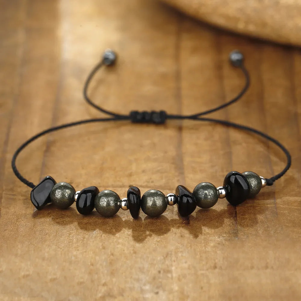Black garnet stone bracelet with geometric beads and moon charm on wrist