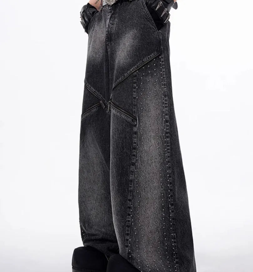 Black and grey washed wide leg cotton denim trousers and matching waistcoat set laid flat.