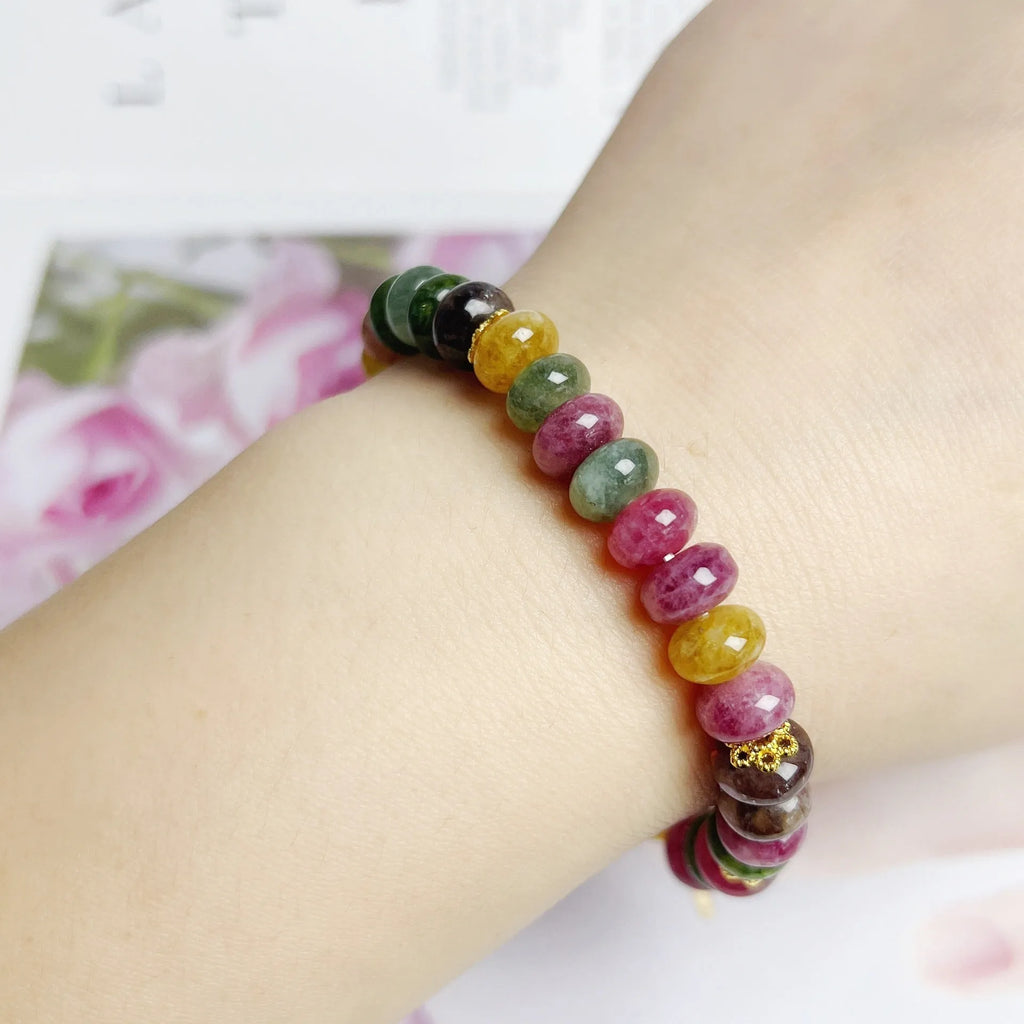 Women's bracelet with colourful tourmaline abacus beads and artificial crystal on wrist.