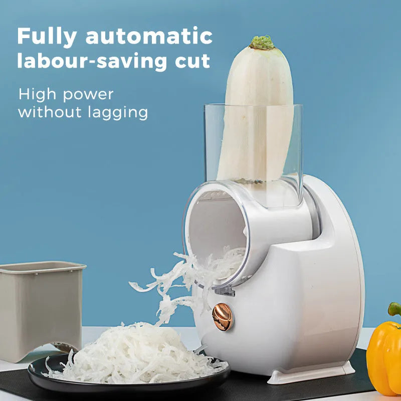 White electric vegetable slicer with rotary grater, suction base, and set of three blade pairs on a kitchen worktop.