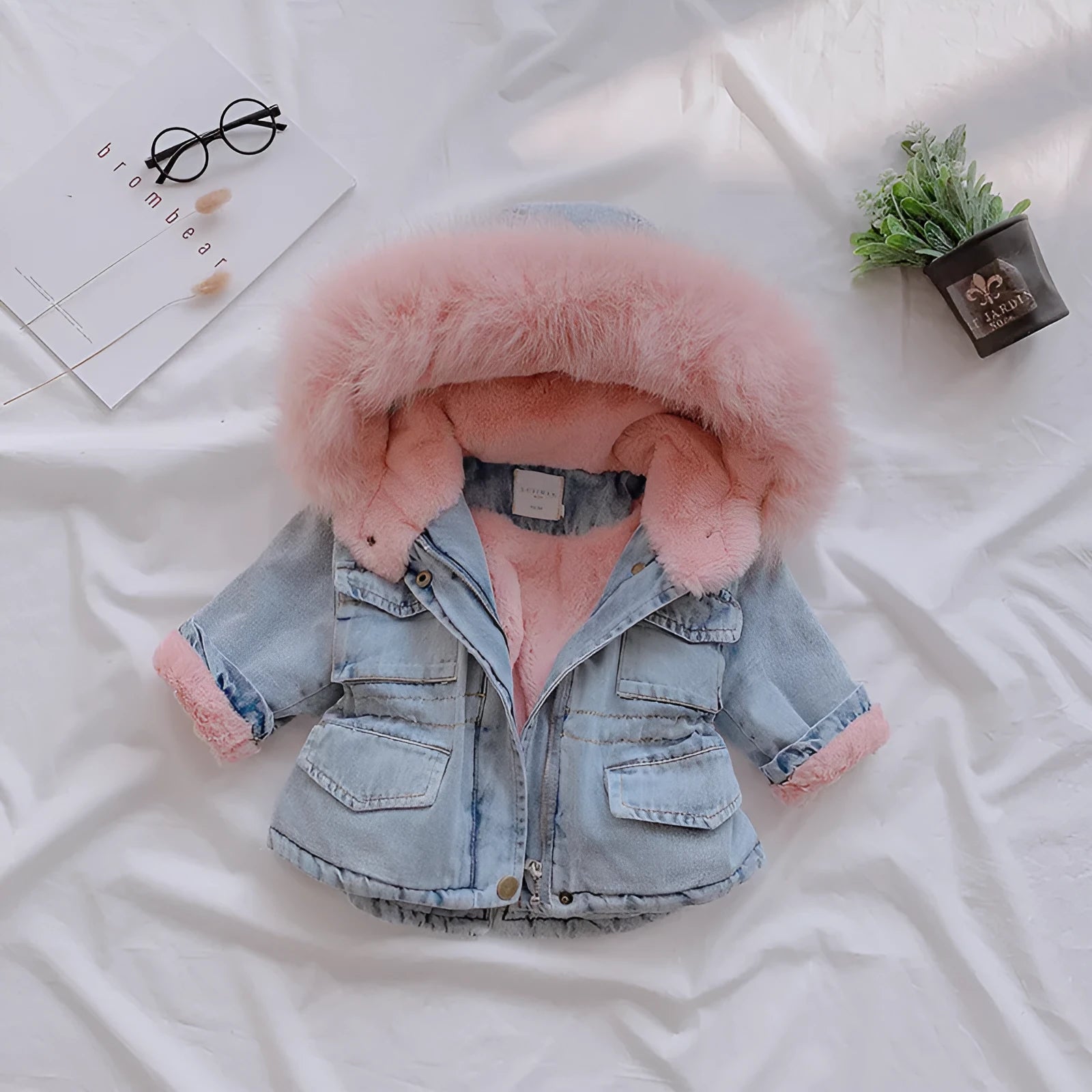 Blue girls denim coat with a faux-fur hood and pink lining visible.
