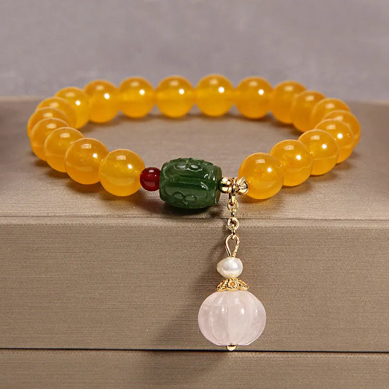 Yellow agate crystal bracelet on a gold silk cord, showing khaki colour and Japanese-Korean style.