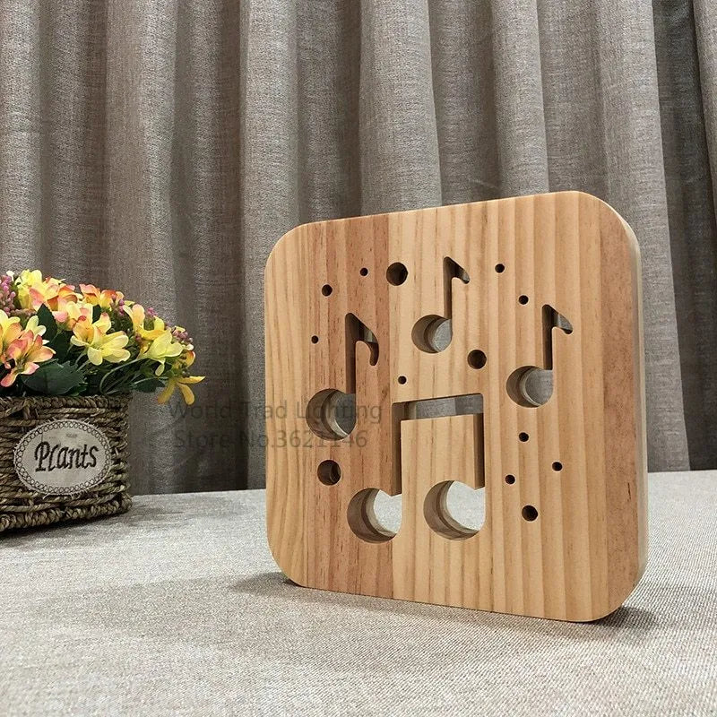 Square pine wood USB lamp with warm white LED glow, showing natural grain texture on a desk.