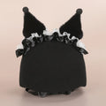Soft plush helmet cap with cartoon character design, shown on a wireless earbud charging case.