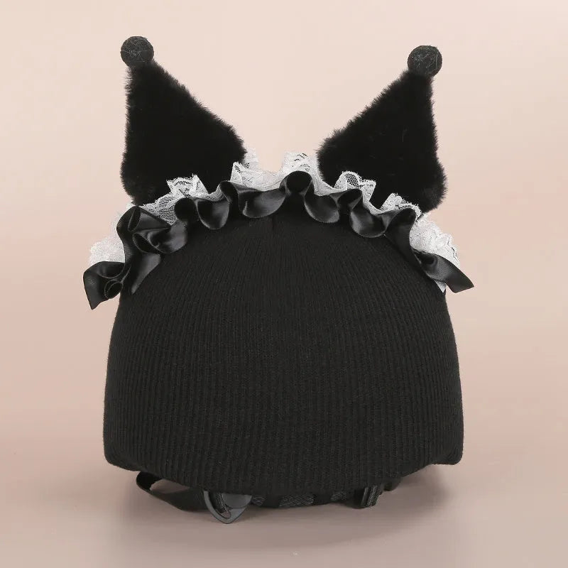 Soft plush helmet cap with cartoon character design, shown on a wireless earbud charging case.