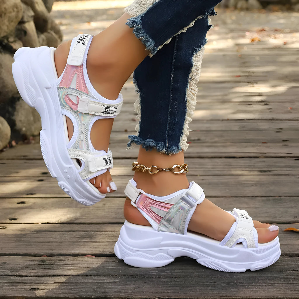 Women's black Roman platform sandals with secure strap design on white background