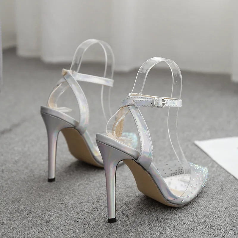 Women's pointed toe stiletto sandals with a diamond detail on a glossy PVC upper.