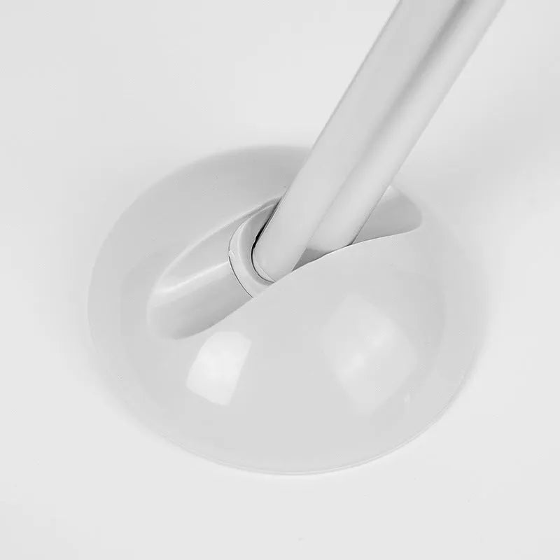 White remote control LED night light lamp on a wooden surface.