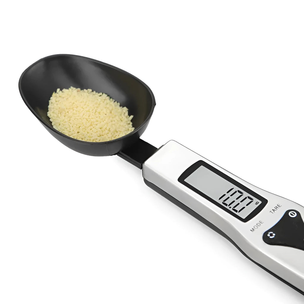 Digital measuring spoon with electronic display showing weight measurement in grams