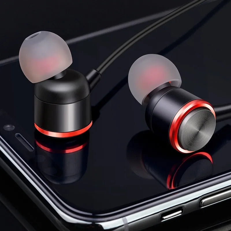Wired in-ear gaming headset with 3.5mm plug, silicone ear tips, and built-in microphone, shown with storage box