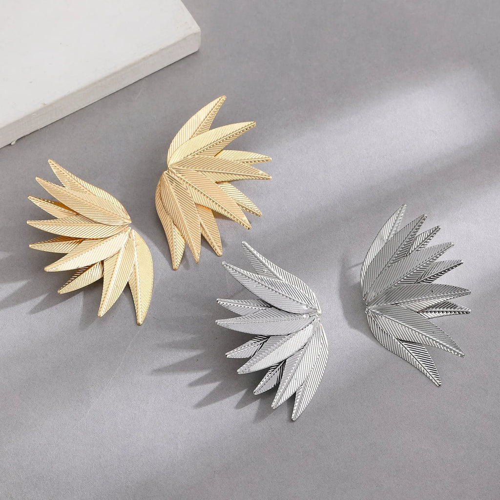 Alloy metal leaf silhouette earrings in white and gold colour options showing botanical jewellery design
