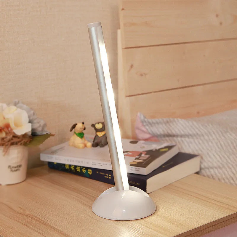 White remote control LED night light lamp on a wooden surface.
