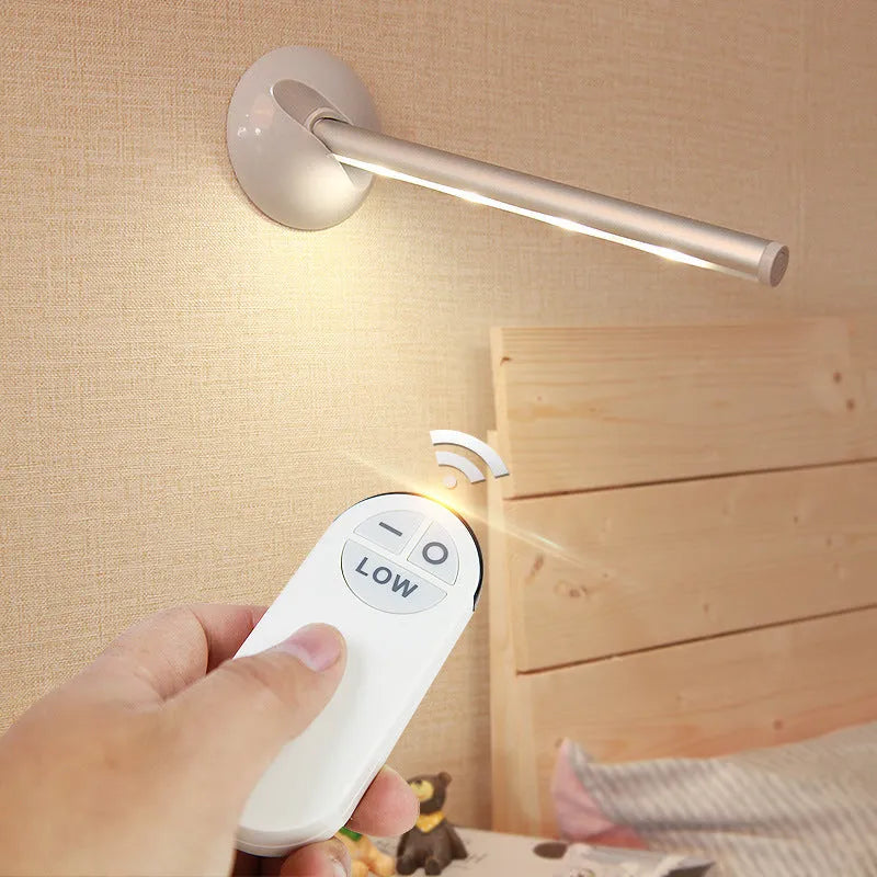 White remote control LED night light lamp on a wooden surface.