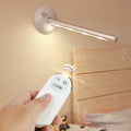 White remote control LED night light lamp on a wooden surface.