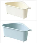 Beige plastic triangle kitchen sink rack holding a sponge and soap, hanging from a faucet.