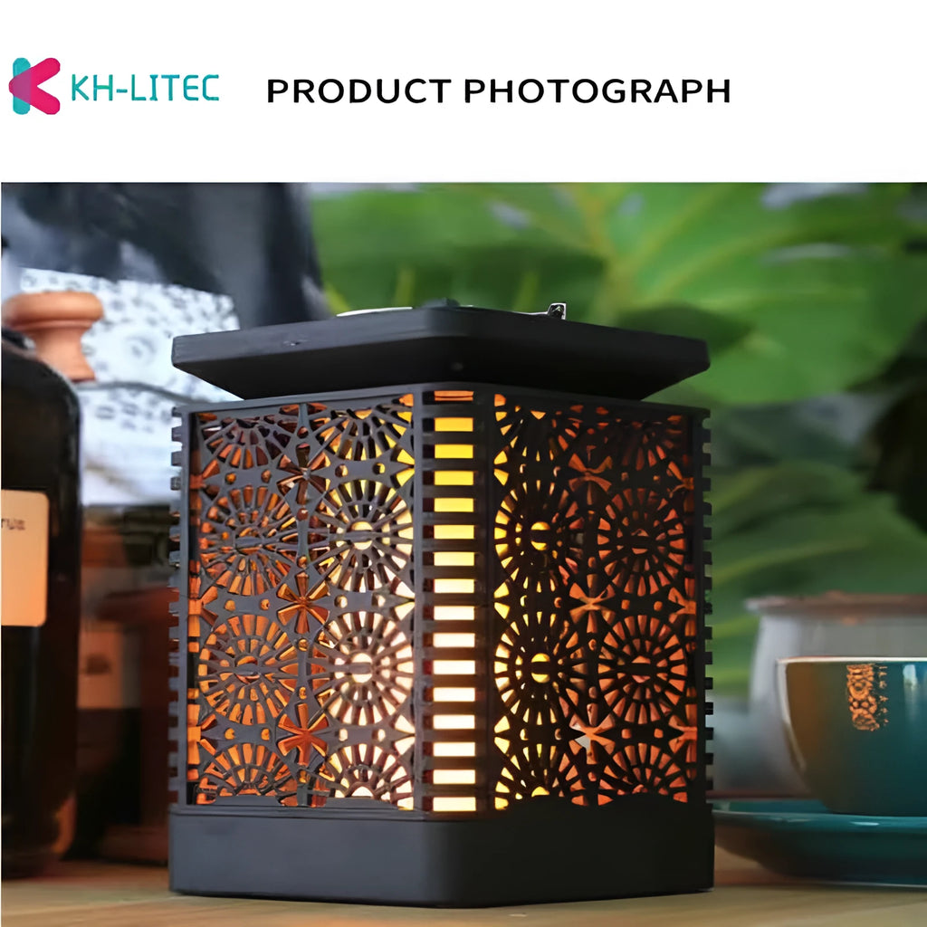 Set of four black solar-powered garden torch lights with flickering flame LED effect on a patio.