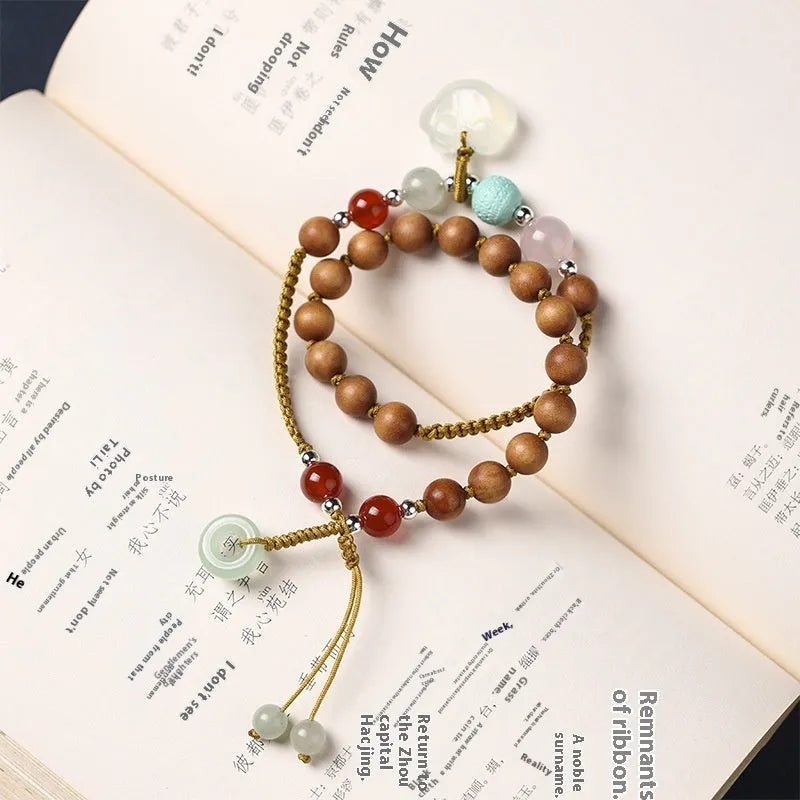 Hand-woven women's sandalwood bracelet with double-ring design and traditional gemstone accents