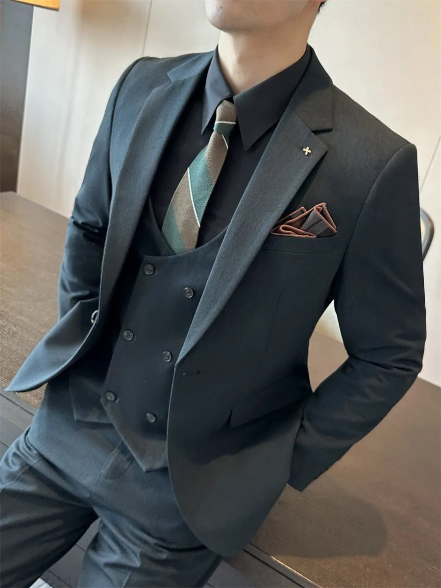Men's slim fit dark green business suit jacket with structured shoulders on a hanger.