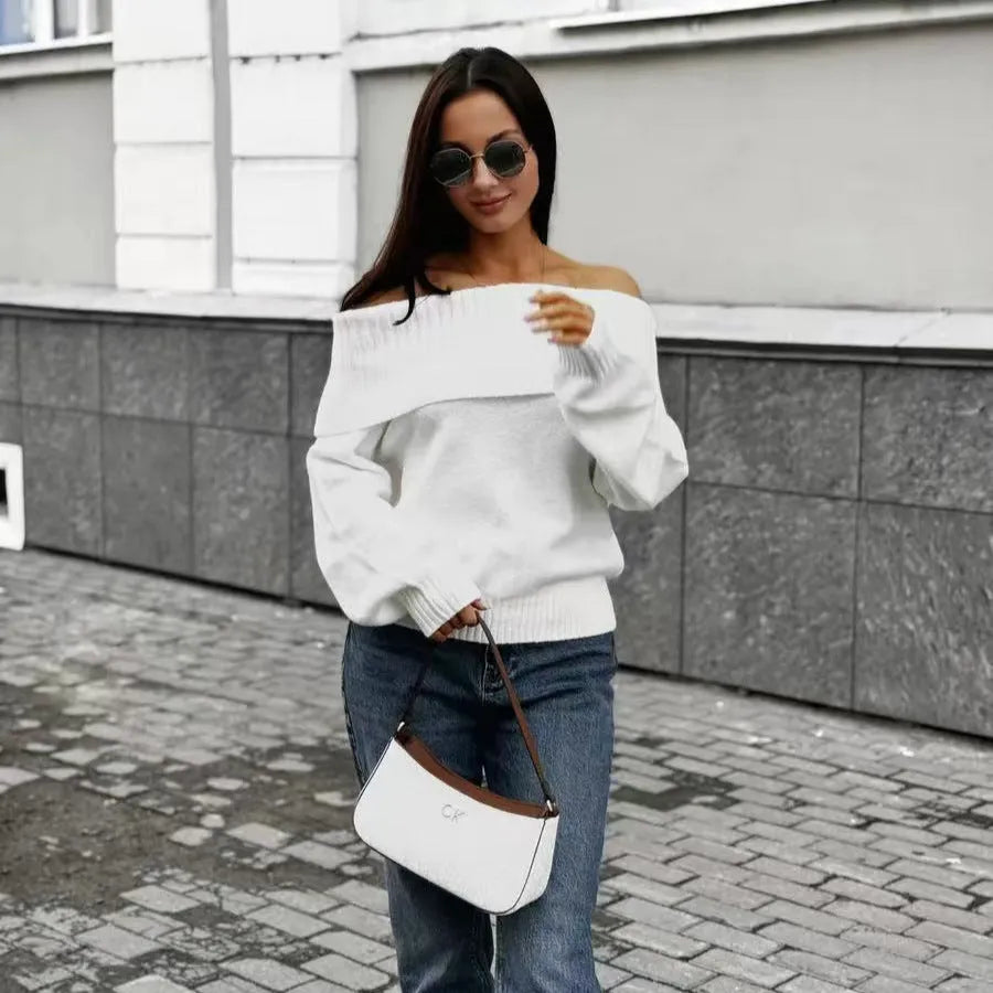 Grey off-the-shoulder women's sweater with a 3D knit pattern and strapless neckline on a hanger.