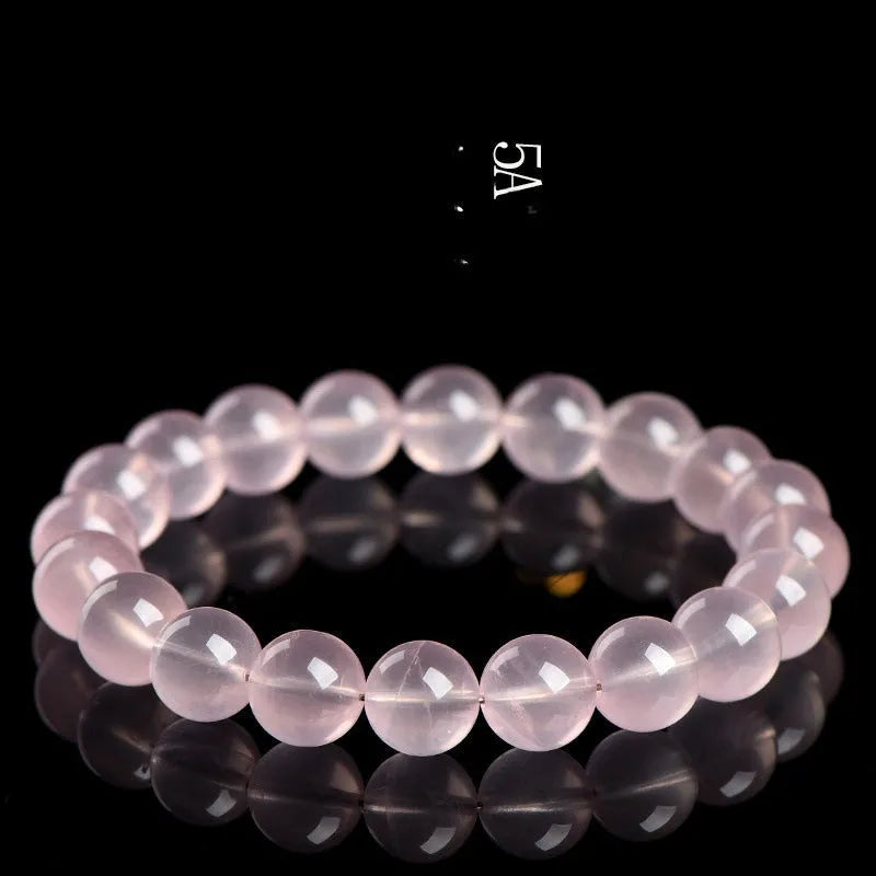 Natural crystal round bead bracelet with polished starlight effect in pink colour, showing bead detail and sizing options