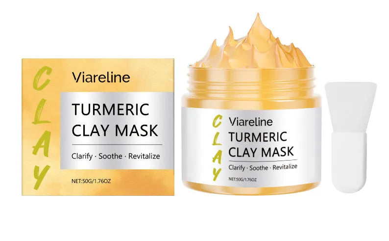 Yellow turmeric mud facial mask with application brush on wooden surface