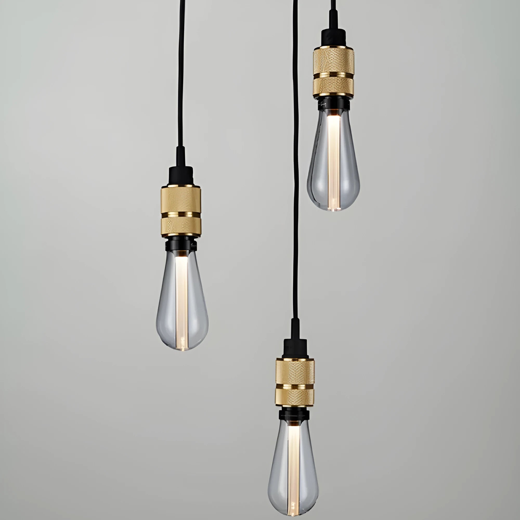 DIY retro chandelier ceiling light kit showing metal lamp holders and woven black cord.