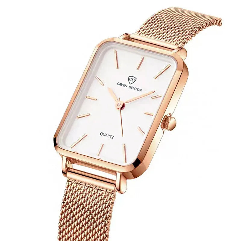 Women's rose gold waterproof quartz watch with woven steel strap on wrist.