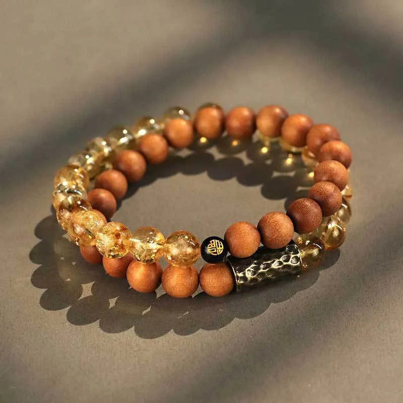 Handmade yellow tower crystal bracelet with double ring design on wrist.