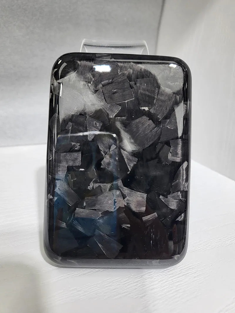 Black Kevlar hard shell case for Apple MagSafe power bank, shown in 3K round hole bright finish.