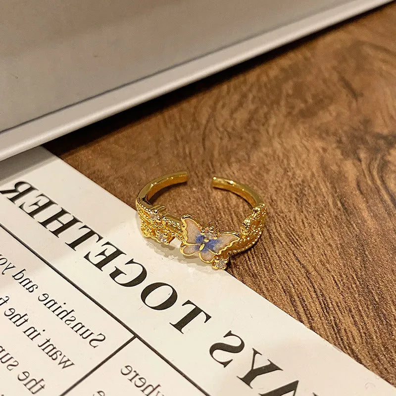 Copper butterfly women's ring with dripping oil texture and an open loop design.