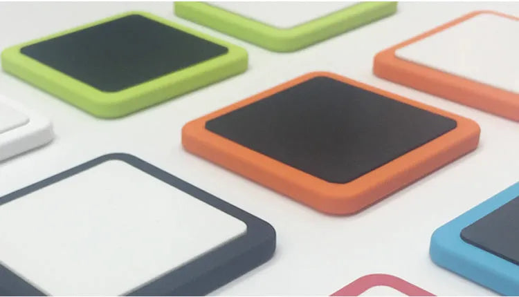White magnetic tablet holder with adhesive base mounted on wall holding iPad