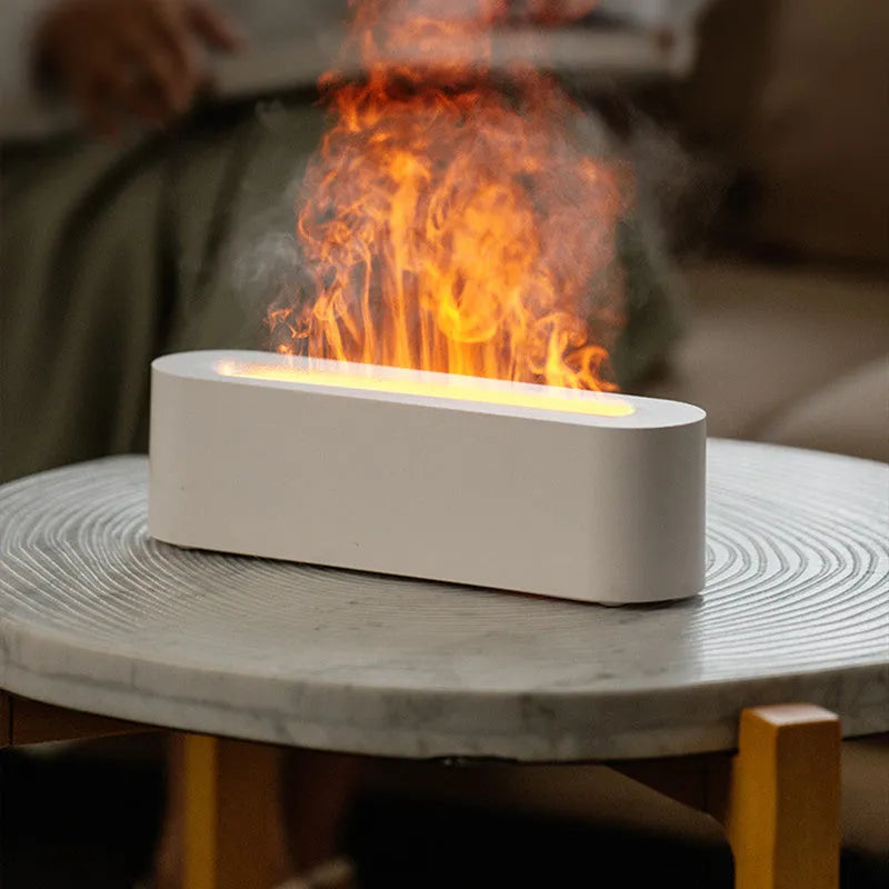 White square plastic flame aroma diffuser humidifier with LED lights and water vapour mist.